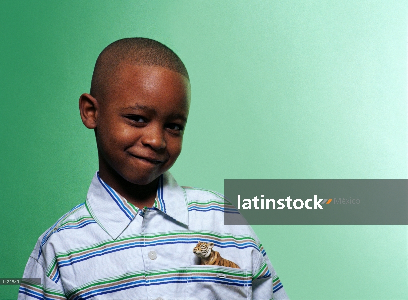 Boy with toy tiger in pocket