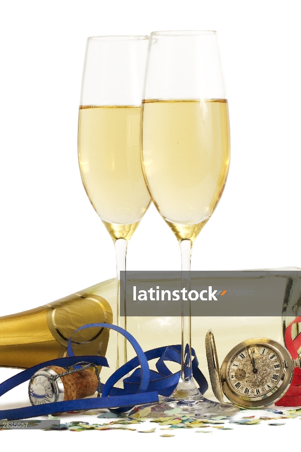 two glasses champagne pocket watch streamer cork and confetti front of champagne bottle