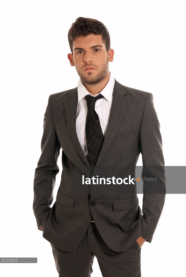 Young businessman looking serious hands in pockets isolated on white background